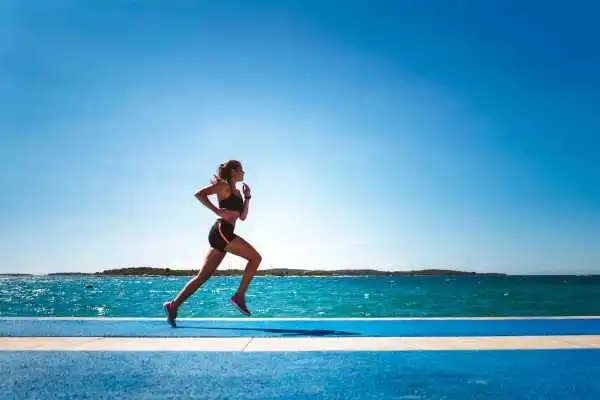 Woman running showing strong leg muscle Renfrew